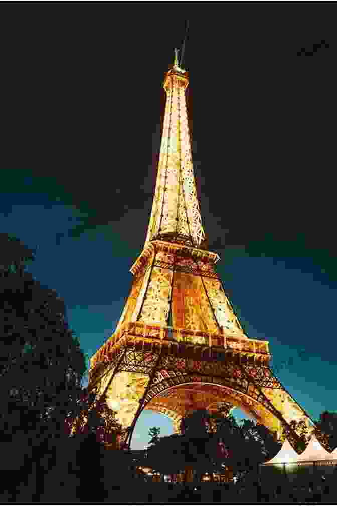 A Stunning Night View Of The Eiffel Tower Illuminated With Golden Lights Evo S Travels J A Parris