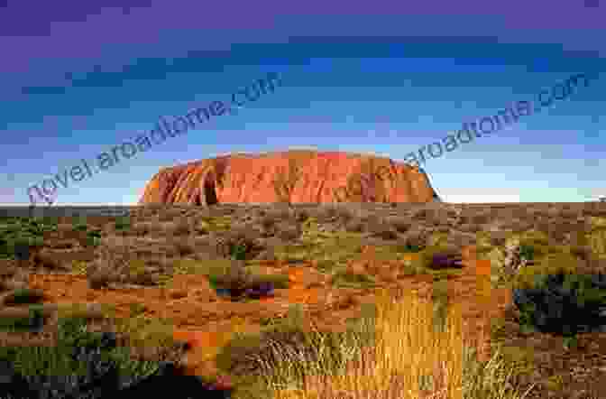 As The Sun Dips Below The Horizon, Uluru's Reflection Shimmers In A Nearby Waterhole, A Poignant Reminder Of The Timeless Beauty And Fragility Of The Outback. FINDING ULURU Raymond Barfield