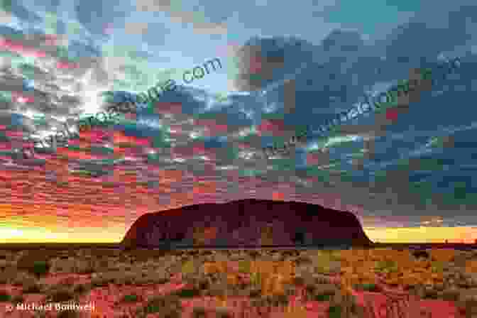 Barfield Ascends Uluru's Winding Track At Sunrise, The Vibrant Colors Of The Dawn Illuminating His Path And The Vast Outback Unfolding Beneath. FINDING ULURU Raymond Barfield